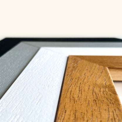 a close-up view of a wooden surface with a textured, natural grain pattern. The wooden surface is positioned next to a white surface, creating a contrast between the two materials.
