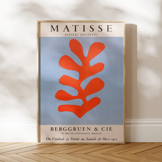 a poster for the exhibition "MATISSSE" by the artist Jean-Michel Basquiat, which took place in Berggruen, Paris from 28 to 29 March 1973. The poster showcases a large abstract leaf-like shape in red and blue colors.