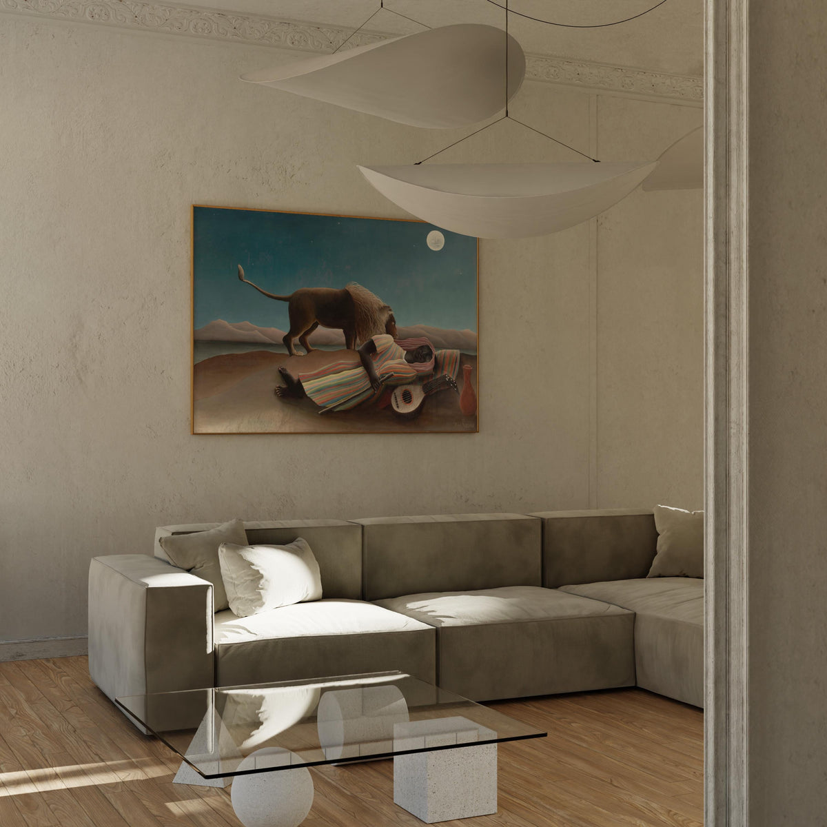 a modern living room with a large painting of a lion on the wall, a glass coffee table in the center, and a comfortable gray sofa.