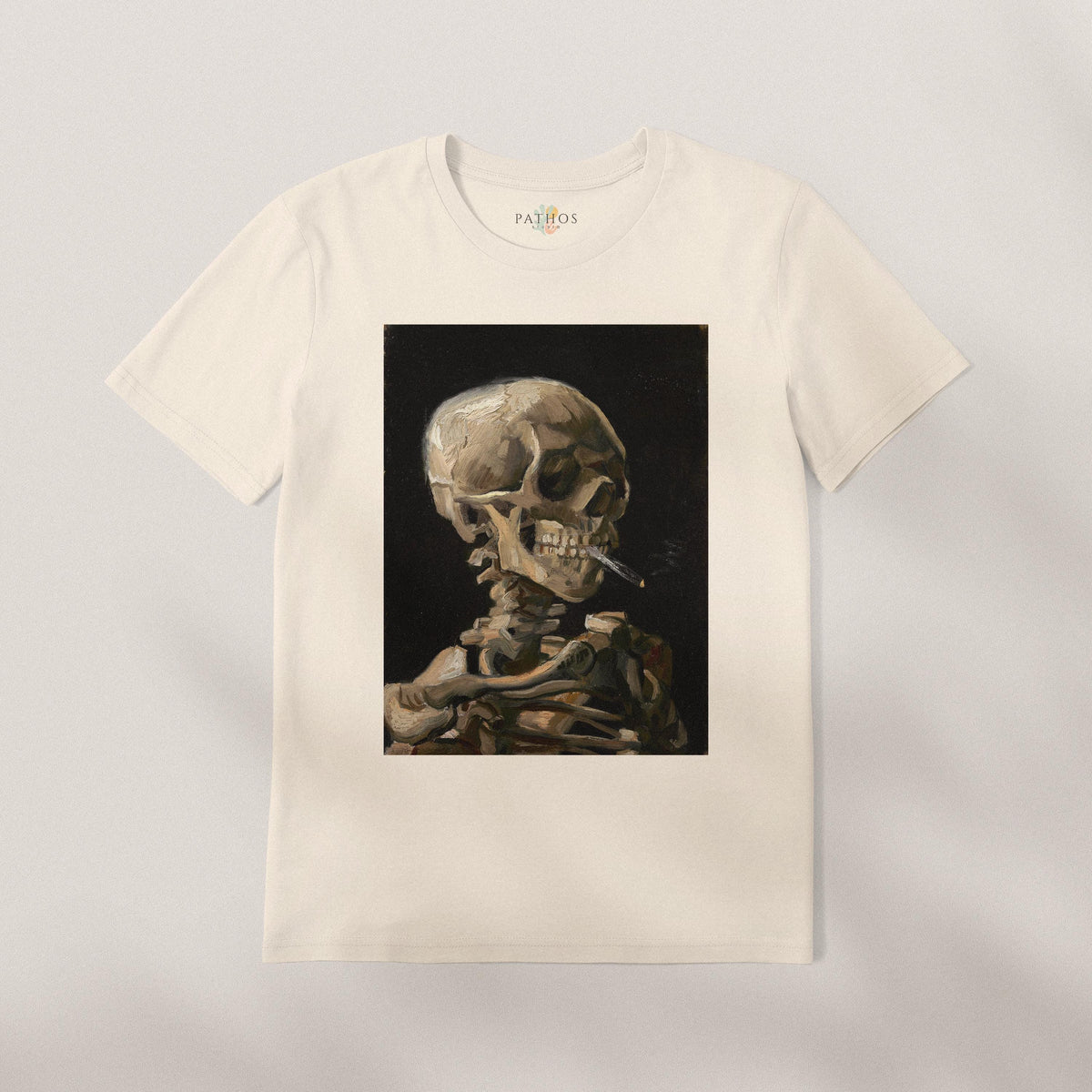 A white t-shirt with a framed image of a skeleton smoking a cigarette.