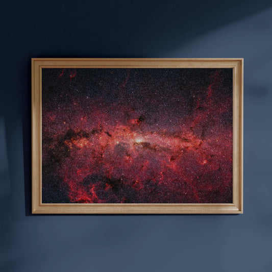 The image is a framed photograph of a distant galaxy, with a vibrant red and orange color palette and a dark background.