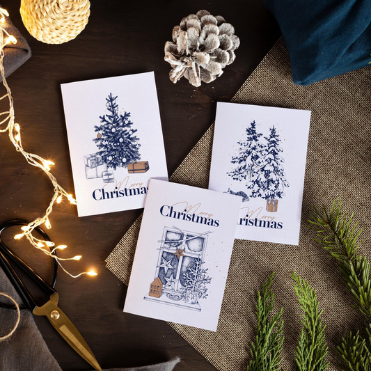 A set of 3 matching christmas cards with blue illustrations of christmas trees, presents and decor