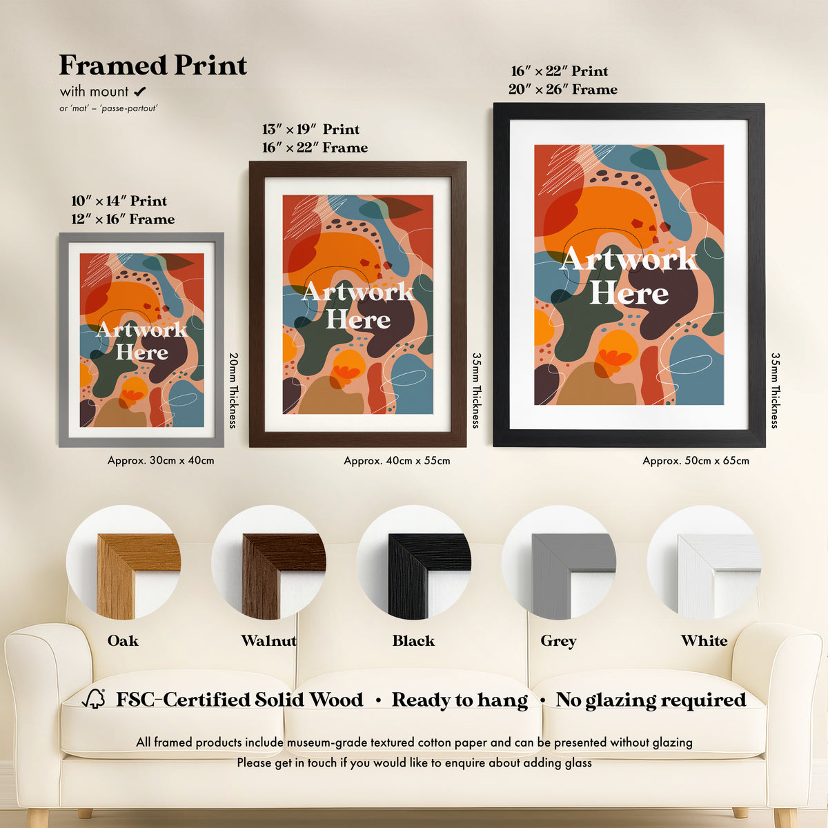 a living room with a white couch and two framed pictures on the wall