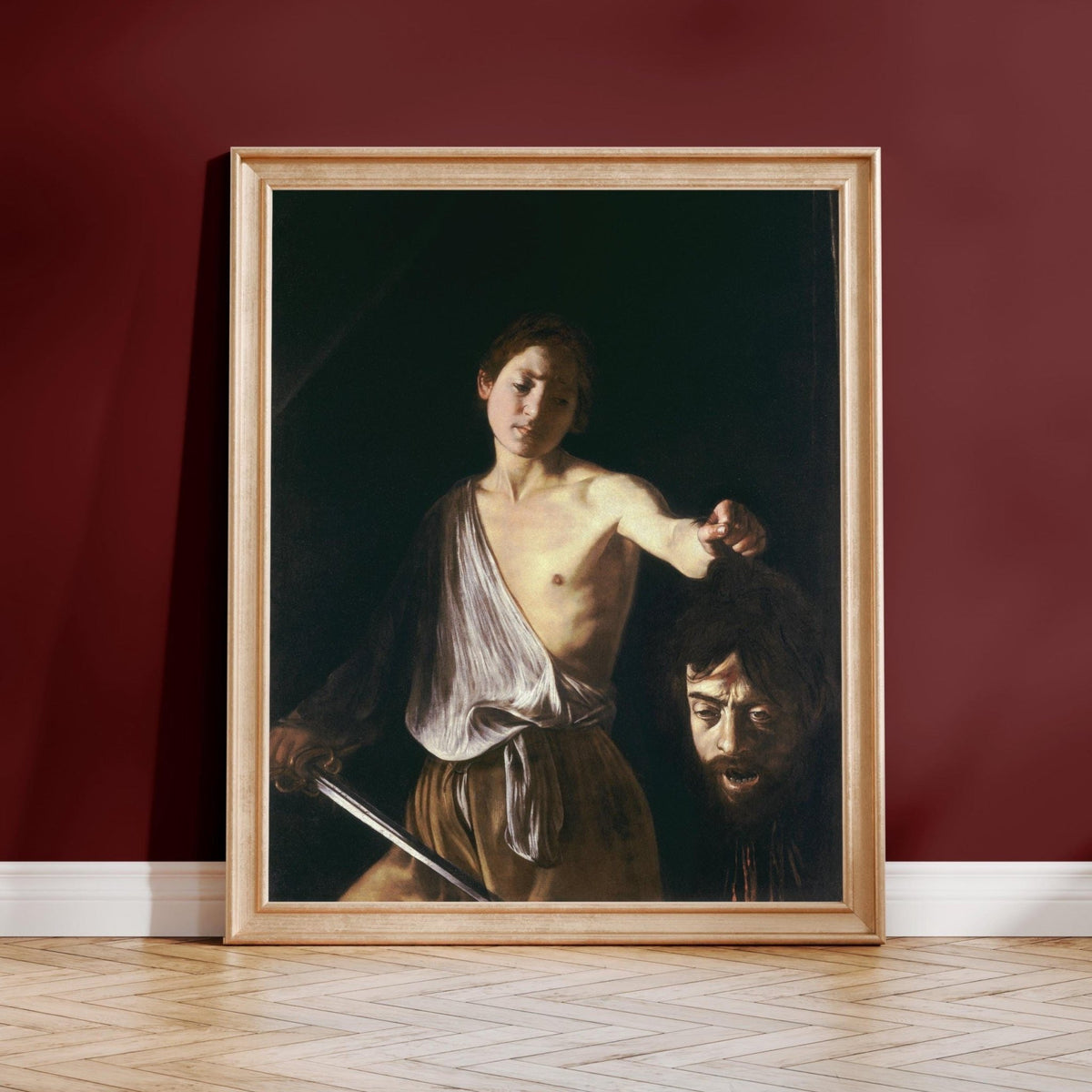 The image is a framed painting depicting a man with a sword, holding a head of a person.