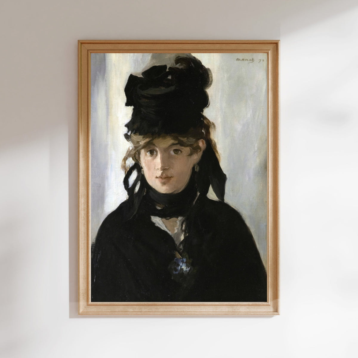 The image is a framed painting depicting a woman wearing a black hat and coat, with a pensive expression on her face.