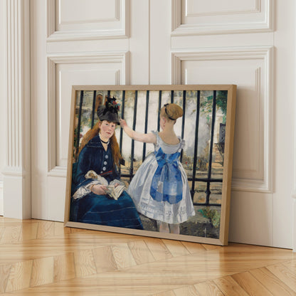 A framed painting depicting two women, one wearing a blue dress and the other in a black dress, sitting together and engaged in conversation.