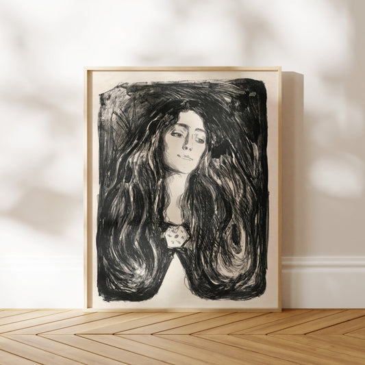 a framed black and white portrait of a woman with long, flowing hair.