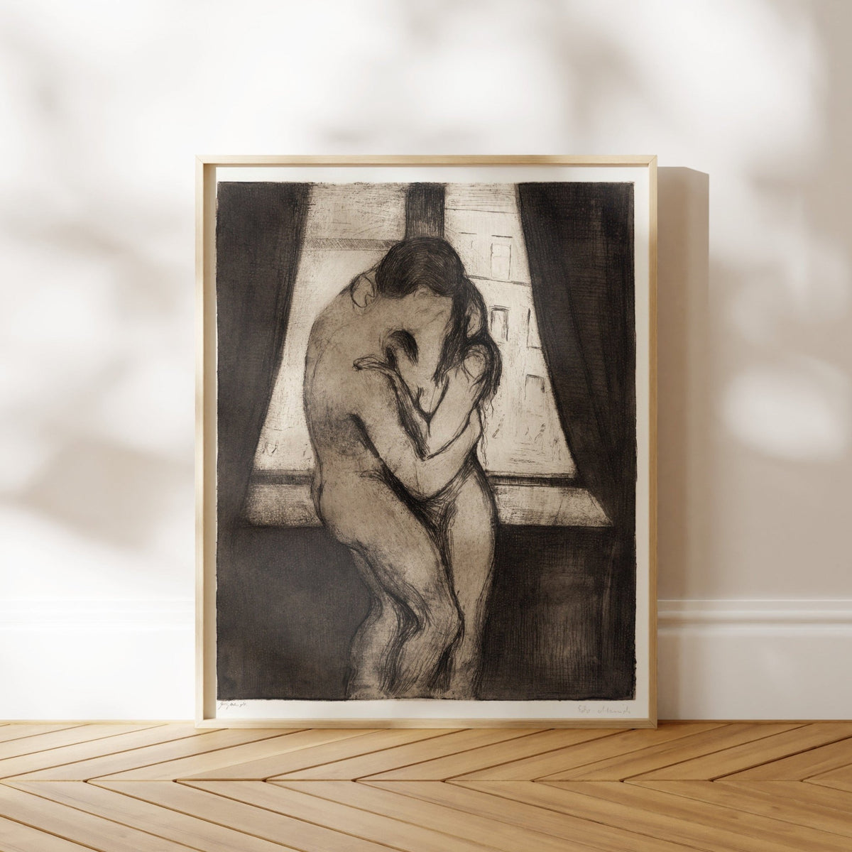 The image is a framed black and white sketch of a couple embracing in front of a window.
